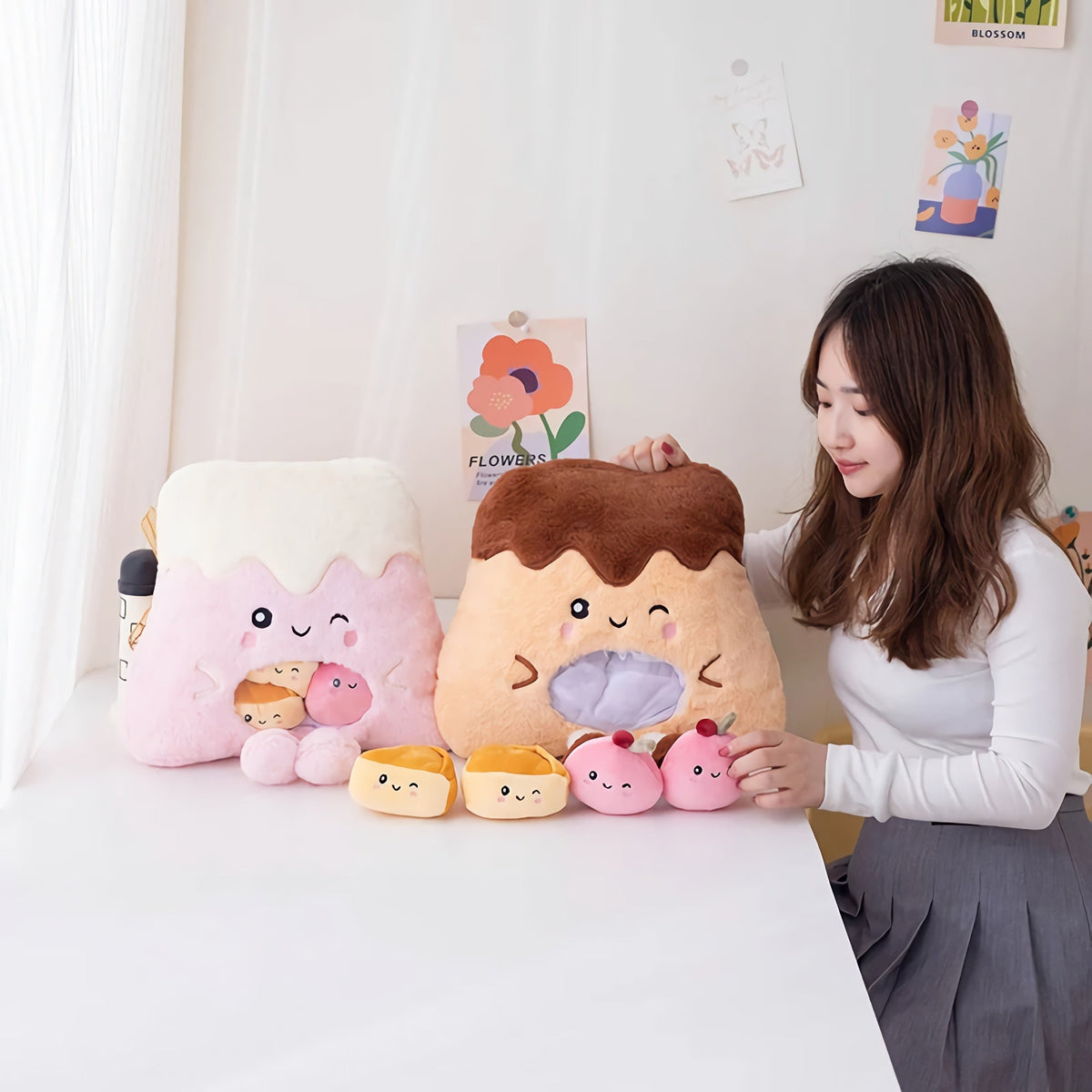 Woman arranging plush dessert-themed Peekaboo gift set toys on a table