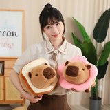 Woman holding a bread capybara plush and a pink flower capybara plush