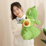 Woman smiling holding a green dinosaur plush with avocado backpack at a desk