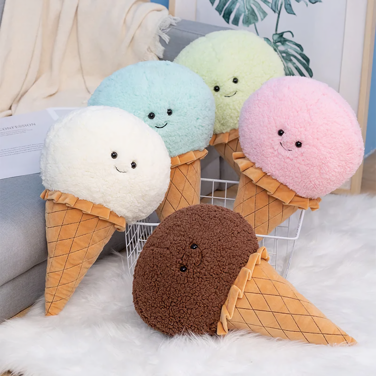 Five ice cream cone plush pillows in white, blue, mint green, pink and brown on a gray sofa