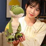 Woman holding green T-Rex dinosaur plush with cream belly and chunky feet.