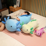 Girl sleeping on a large blue axolotl plush with green and purple axolotl plushies on a bed