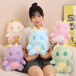 A woman holding a blue Kawaii Baby Dragon Plush with sparkly star eyes, surrounded by pink, white, green, and purple plushies
