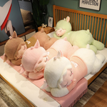 Sleeping sheep plush pillows in brown, pink, white and green lying together on a bed
