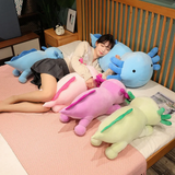 Girl lying on a bed with pink, purple, blue and green axolotl plush pillows around her