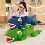 Woman reading on a rug with a blue T-Rex plush pillow and a green one
