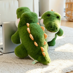 Green alligator plush toys on a rug next to a laptop