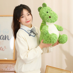 Woman holding a large green dinosaur plush indoors