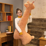 Woman standing and hugging a tall brown long alpaca plush pillow