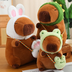 Capybara plushies in rabbit, dinosaur and frog hoods with matching mini bags