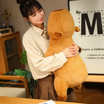 Woman standing and hugging a tall capybara plush pillow