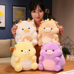 Woman holding a white Kawaii pig-dragon plush, surrounded by peach, yellow, and purple ones on a sofa.