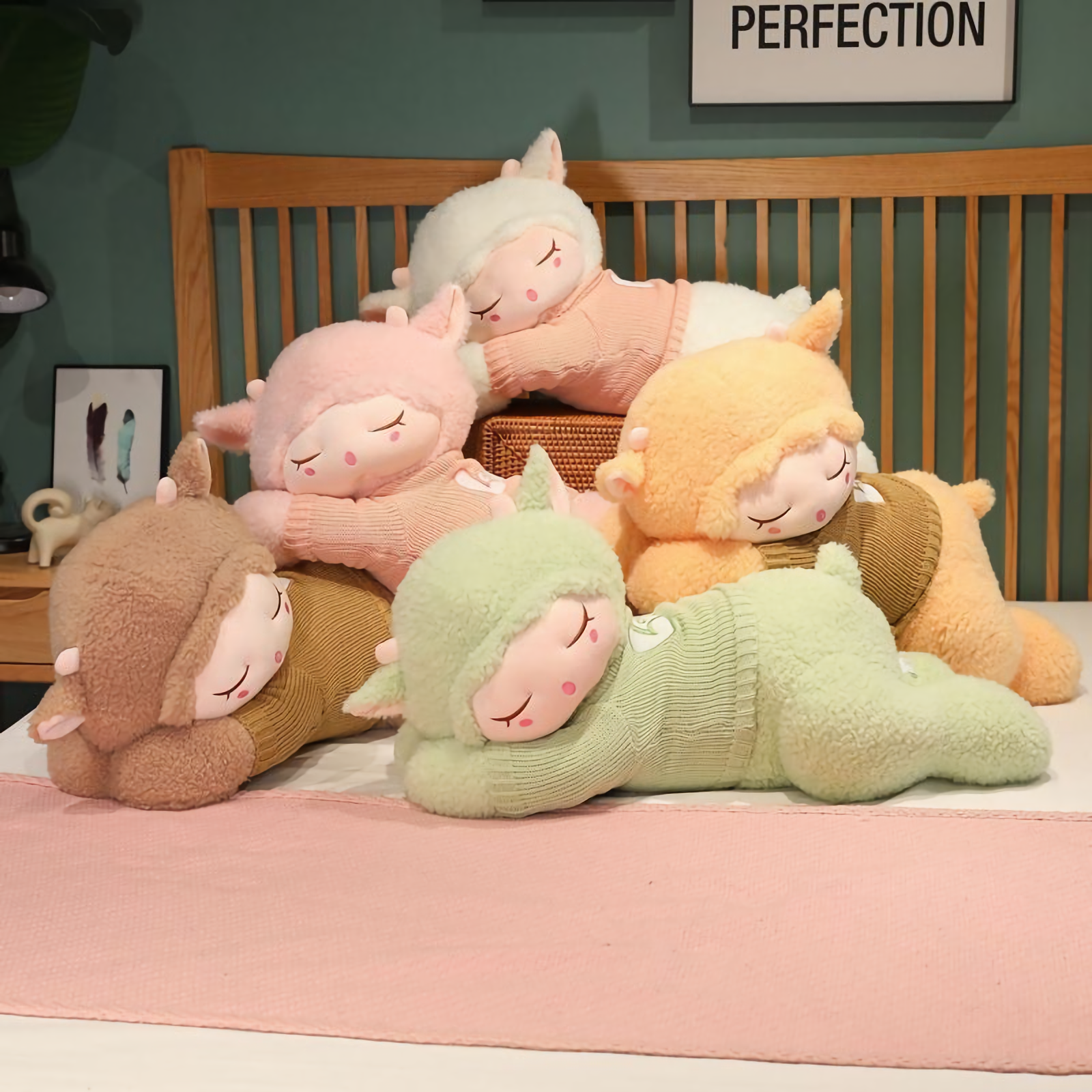 Group of sleeping sheep plush pillows in brown, pink, orange, green and white stacked on a bed