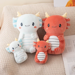 Light blue and burgundy axolotl dragon plushies in two sizes sitting on a sofa