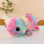 Rainbow tie-dye axolotl plush pillow with pink, blue and yellow colors and blushing cheeks