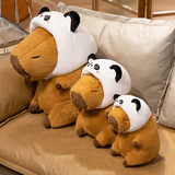 Three capybara plushies in panda hoods of different sizes on a sofa