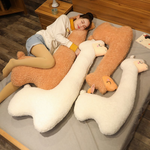 Woman lying on a bed with white and brown long alpaca plush pillows
