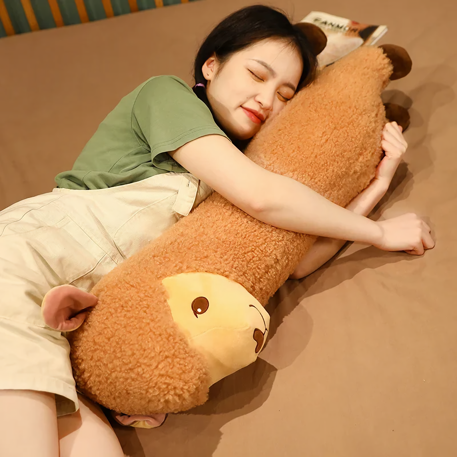 Woman lying on a bed hugging a long brown alpaca plush