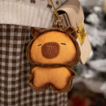 Bread capybara plush hanging from a handbag on a chain