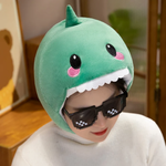Woman with sunglasses wearing a green dinosaur hood