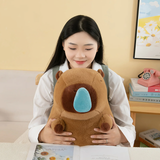 Woman holding a small brown capybara plush with a blue nose bubble