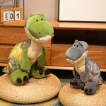 Two Chunky T-Rex Dinosaur Plush toys, one green and one gray, sitting on woven mats.