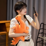 Woman holding orange Stegosaurus plush, looking at something off-camera.