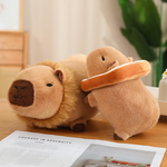Lion capybara plush and a bread capybara plush on a wooden table