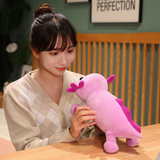 Girl holding a purple axolotl plush with pink gills and a smiling face