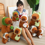 Woman with a group of hooded capybara plushies and lotus leaf capybaras on the floor