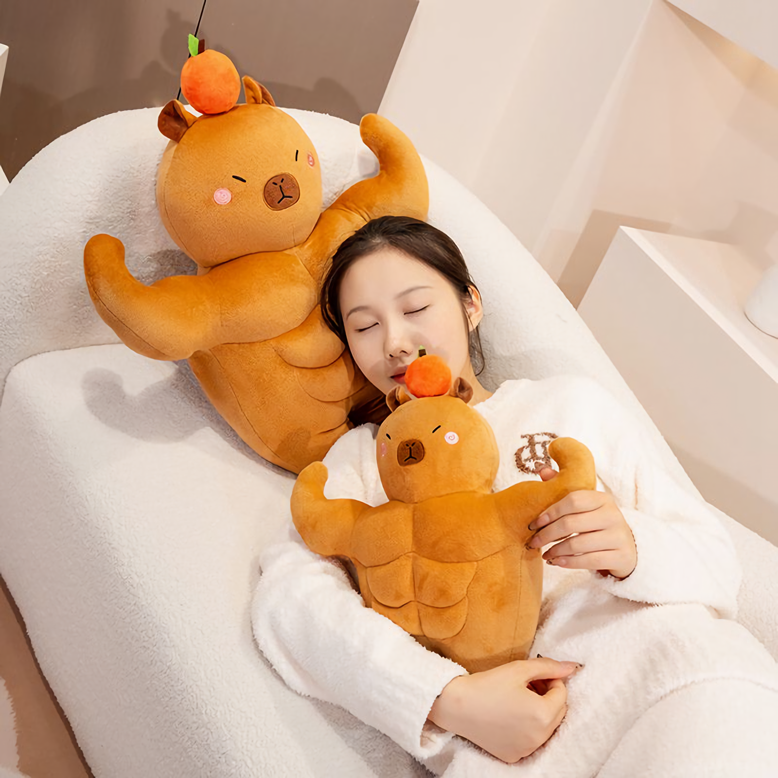 Woman lying on a sofa with two muscle capybara plushies
