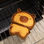 Bread capybara plush on a wire baking rack