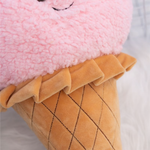 Close-up of a pink ice cream cone plush pillow with a quilted waffle cone