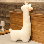 White long alpaca plush pillow standing against a wooden headboard