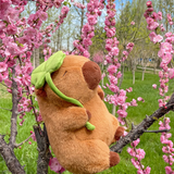 Lotus leaf capybara plush sitting in a blossoming tree