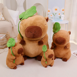 Lotus leaf capybara plushies in different sizes beside a white shelf