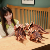 Woman arranging three brown Triceratops plush toys on a wooden table.