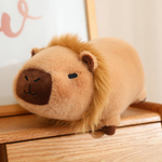 Lion capybara plush with a fluffy mane on a wooden shelf