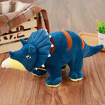 Blue Triceratops dinosaur plush with a frill on a wooden floor