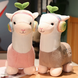 Pink and gray alpaca plushies with music note headphones sitting side by side