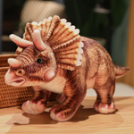 Brown Triceratops dinosaur plush with detailed frill and horns stands on a wooden surface.