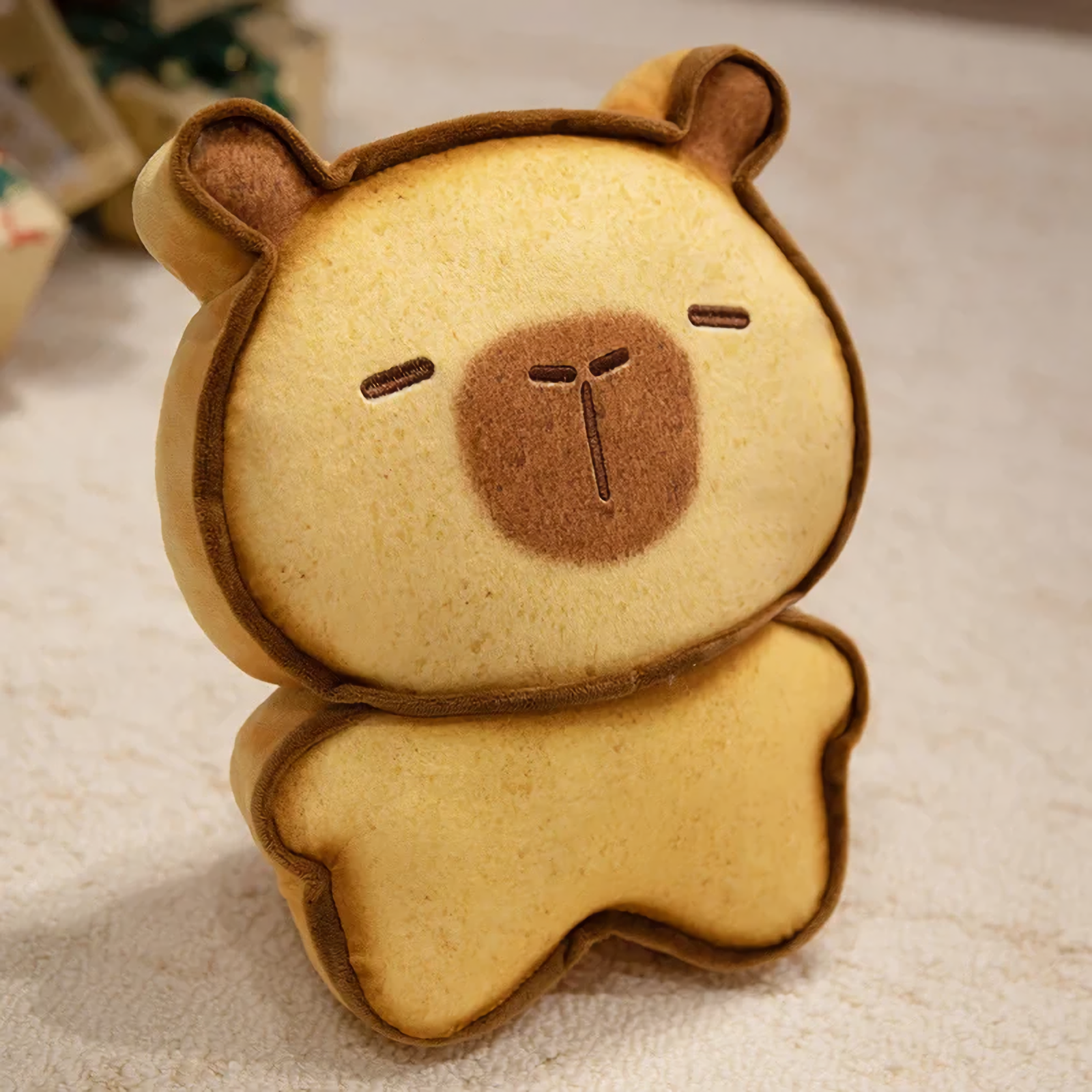 Light brown bread capybara plush with a tiny embroidered face