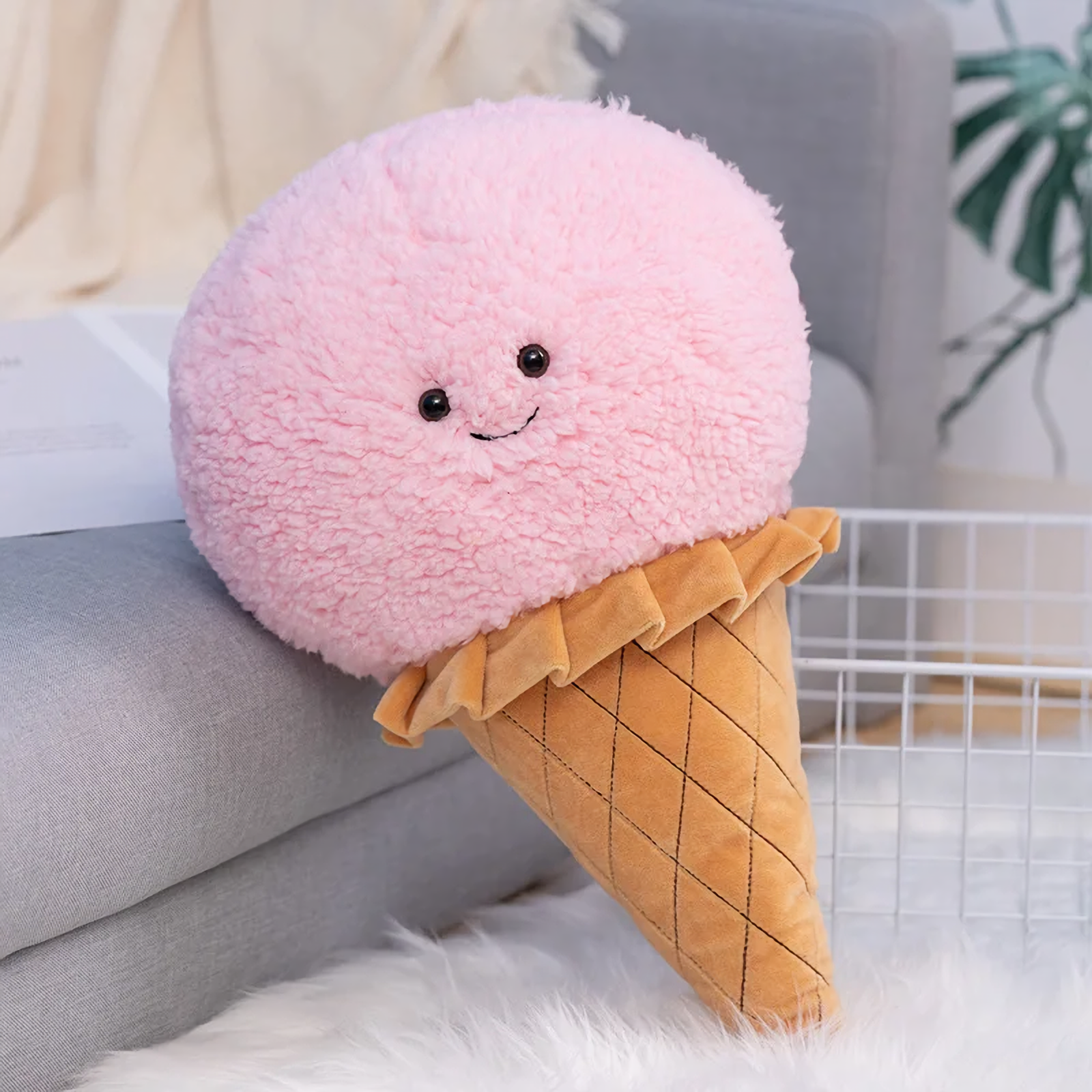 Pink ice cream cone plush pillow with a smiling face and a quilted waffle cone