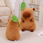 One lotus leaf capybara plush from behind beside a taller one