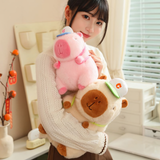 Woman hugging a pink and a brown capybara plush with white caps