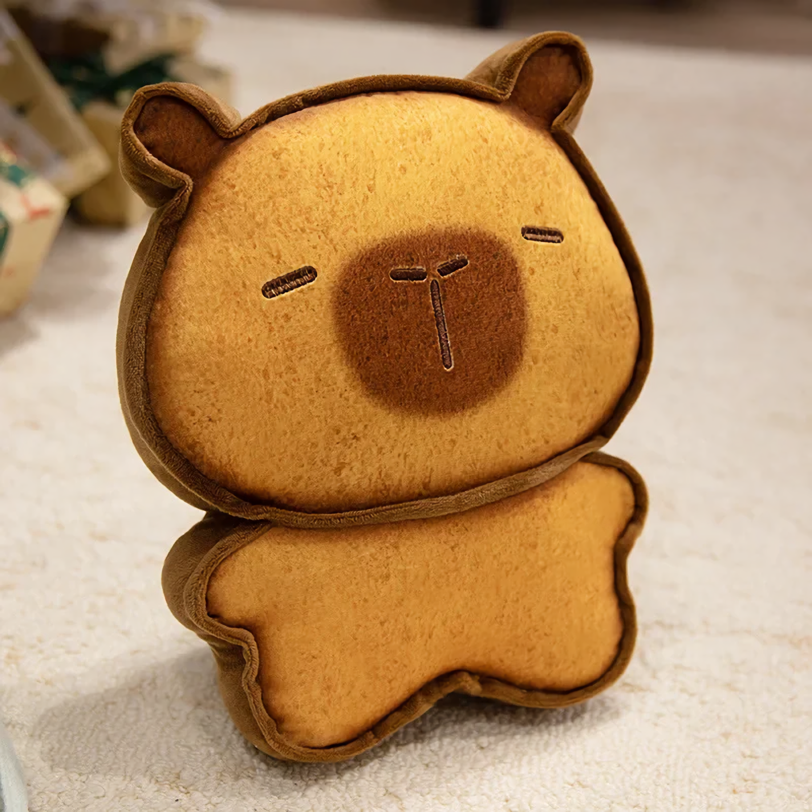 Dark brown bread capybara plush with a tiny embroidered face