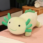 Green axolotl plush pillow with darker green gills and a smiling face