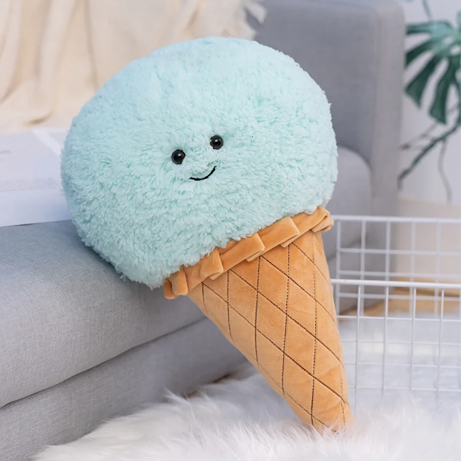 Blue ice cream cone plush pillow with a smiling face and a quilted waffle cone