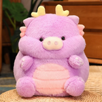 Purple pig-dragon plush with tiny horns, cream belly, on a wicker mat. Fluffy round body with a small pig snout.
