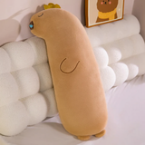 Long tan capybara body pillow with a blue nose drop and a gold crown leaning on a cloud headboard